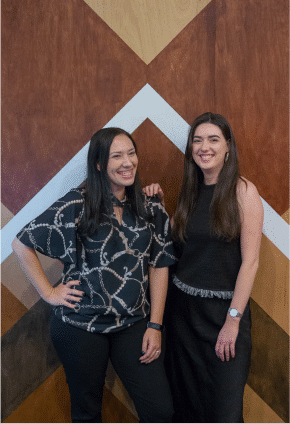 Two girls smiling at The Indigo Project front desk