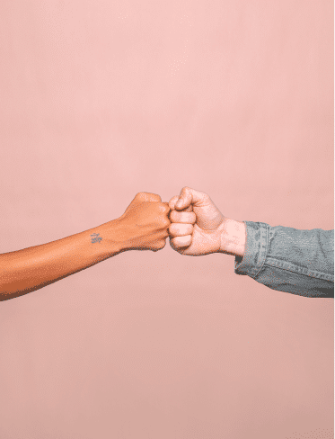 A woman and man fist bump