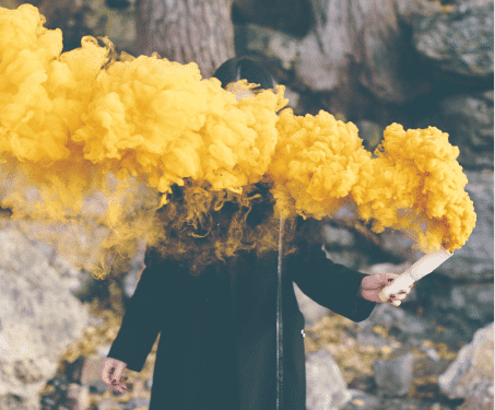 Girl holding yellow smoke