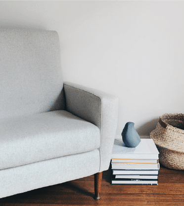 A chair and books in The Indigo Project practitioner room