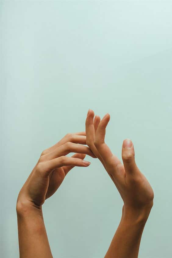 Hands on green background to show you how to feel more connected