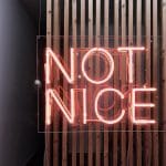 Red neon sign saying "not nice"