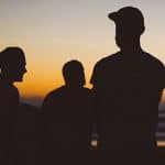 Silhouettes of men in caps