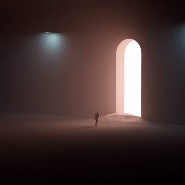 A small figure walking through a large lit archway