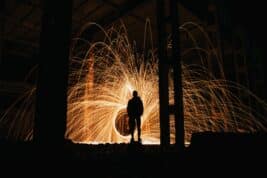 Narcissist Page Image: A silhouette of a man watching a fire explosion