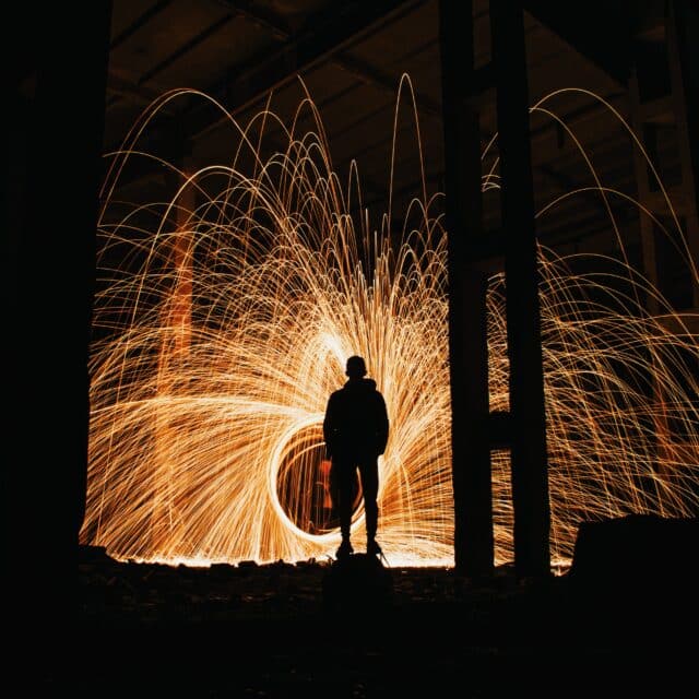 Narcissist Page Image: A silhouette of a man watching a fire explosion