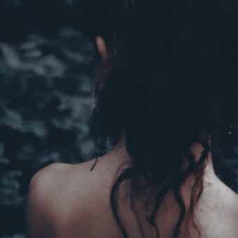 A figure stares into the distance