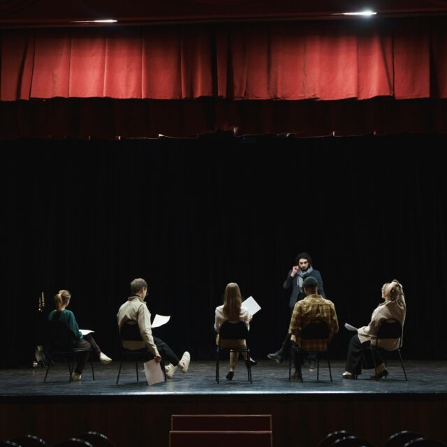 Internal Family Systems: A group of actors playing different roles rehearse their lines on a stage