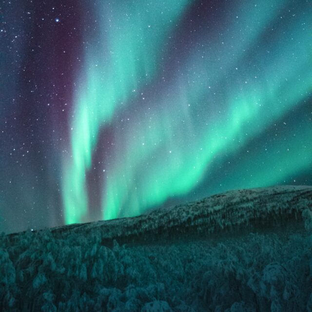 The northern lights; blue and green light in the skies