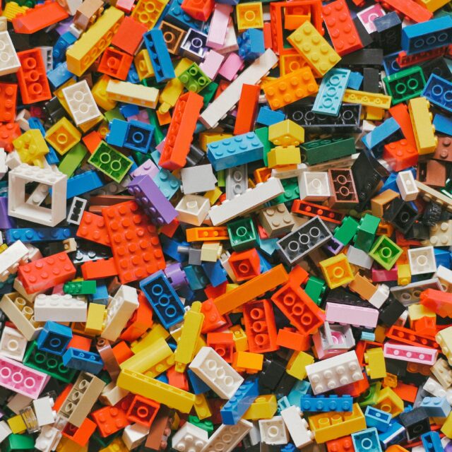 An image of multi-coloured lego pieces all collected into a pile. They vary in shapes and sizes.