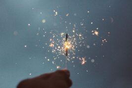 A hand holds a spark